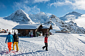 Timber hut in Winter on Maennlichen mountain with Eiger Moench and Jungfrau in the background, Grindelwald, canton of Bern, Switzerland