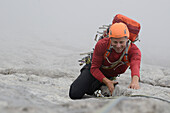 Climber ascending Detassis, Cima Brenta Alta, Dolomites, Trentino, Italy