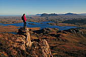 Female hiker at Stac Pollaidh, Suilven in background, Inverpolly Nature Reserve, Highlands, Scotland, Great Britain