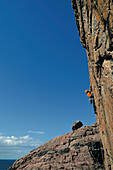 Mann klettert in der Route Bloodlust, Klippen von Sheigra, Highlands, Schottland, Großbritannien