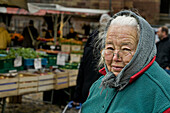 Market woman on Muensterplatz square, historic center, Freiburg im Breisgau, Black Forest, Baden-Wuerttemberg, Germany