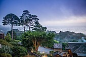 Room with a View from Room 101 Highlands Inn overlooking the Pacific Ocean and cedar trees at dusk with a gathering storm cloud approaching.