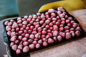 Frozen strawberries on baking tin
