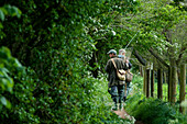 Two people on a path going fishing