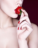 Woman eating strawberry