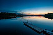 Lake and wooden pier at dawn, Skelleftea, Lapland, Sweden