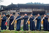 China , Guizhou province , Langde village , Long Skirt Miao people in traditional dress , mens are playing lusheng.