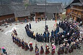 China , Guizhou province , Langde village , Long Skirt Miao people in traditional dress , mens are playing lusheng ,.