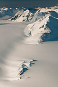 Snow Swept Mountains And A Nunatak On The Harding Ice Field In Kenai Fjords National Park, Southcentral Alaska, Winter