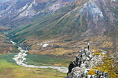 Hiker On Ridge Above Noatak River In Brooks Range, Gates Of The Arctic National Park, Northwestern Alaska, Above The Arctic Circle, Arctic Alaska, Summer.