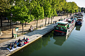 Relaxed atmosphere and strolling on the banks of la villette lake in spring, canal de l‚äôourcq, 19th arrondissement, paris, france