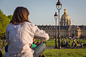 People relaxing on the lawn of the esplanade des invalides, hotel des invalides, 7th arrondissement, paris, france