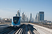 Shot of the metro of dubai and highrises of the financial center in the distance, dubai, united arab emirates, middle east