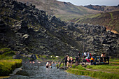 Bathing in a natural hot spring, volcanic and geothermal zone of landmannalaugar, the name literally means 'hot baths of the people of the land', region of the high plateaus, southern iceland, europe