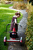 Young Girl Pulling Tricycle