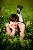 Smiling Young Woman Lying in Field