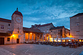 Main square lit up at dusk with cafes, Trogir, UNESCO World Heritage Site, Dalmatian Coast, Croatia, Europe