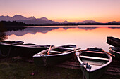 Rowing boats on Hopfensee Lake at sunset, near Fussen, Allgau, Allgau Alps, Bavaria, Germany, Europe