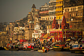 Boats and colorful buildings of Varanasi in the early morning light, India