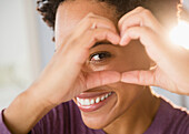 Close up portrait of Black woman forming heart-shape with hands, Jersey City, New Jersey, USA