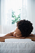 Serene Black woman laying on massage table, Jersey City, New Jersey, USA