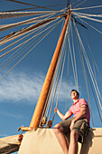 Caucasian man relaxing on sailboat, Cape Town, Western Cape, South Africa