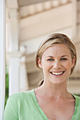 Caucasian woman smiling on porch, Cape Town, Western Cape, South Africa