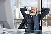 Senior Caucasian businessman talking on headset, Cape Town, Western Cape, South Africa