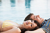 Couple relaxing by swimming pool, Palma de Mallorca, Balearic Islands, Spain