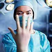 Caucasian surgeon pulling on glove in operating room, Nizniy Tagil, Sverdlovsk, Russia
