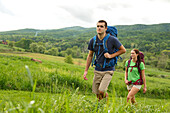 Caucasian couple hiking in rural field, Charlottesville, Virginia, USA