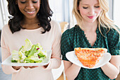 Women eating pizza and salad, Jersey CIty, New Jersey, USA