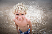 Caucasian boy standing in waves, Sayulita, Nayarit, Mexico