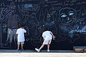 France, Paris 7e arrt, children writing and drawing on a blackboard along a new Seine river's bank