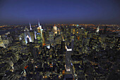 Aerial view of Manhattan at night. On the right, Chrystal Building illuminated