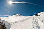 France, Savoie, Tignes, snowboarder walking in the snow