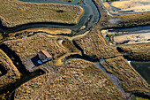 France. Marennes. Aerial view of Marsh Marennes. Channels and a house on the prairie.