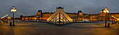 France. panoramic night view of the Louvre in Paris and its pyramids