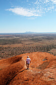 'Tourists walking up Uluru, formerly known as Ayers Rock; Northern Territory, Australia'