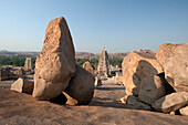 'Large rocks with religious buildings in the background; Hampi, Karnataka, India'