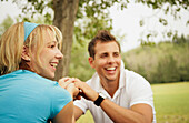A Young Couple Holding Hands In The Park