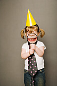 Littly Girl In Party Hat, Holding A Magnifying Glass