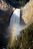 Waterfall Over Cliff Creating A Rainbow