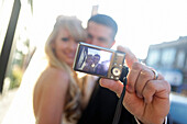 'A Bride And Groom Taking A Self Portrait With A Camera; St. Catherine's, Ontario, Canada'