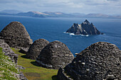 'Skellig Michael, County Kerry, Ireland; Stone 'beehive' Monk Huts (Clochans) With A View Of Skellig Beag'