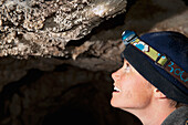 'Woman Inspecting Cave Popcorn; Fernie, British Columbia, Canada'