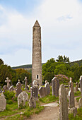 'Tombstones In A Cemetery And A Round Tower On A 6Th Century Monastic Site; Glendalough, County Wicklow, Ireland'