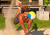 'A Man Diving For A Beach Ball; Tarifa, Cadiz, Andalusia, Spain'