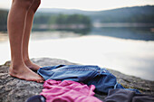 'Feet And Clothing On A Rock By A Lake; Kristiansand, Norway'