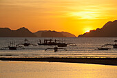 'Sunset View Of Islands And Boats From The Beaches Of Corong Corong Near El Nido; Bacuit Archipelago, Palawan, Philippines'